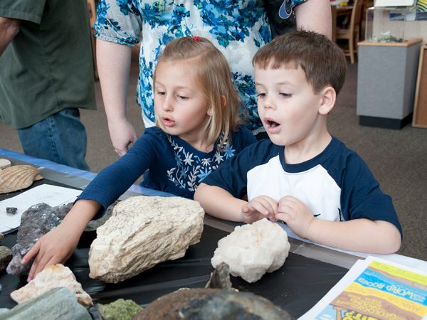 Kids exploring rocks, half header
