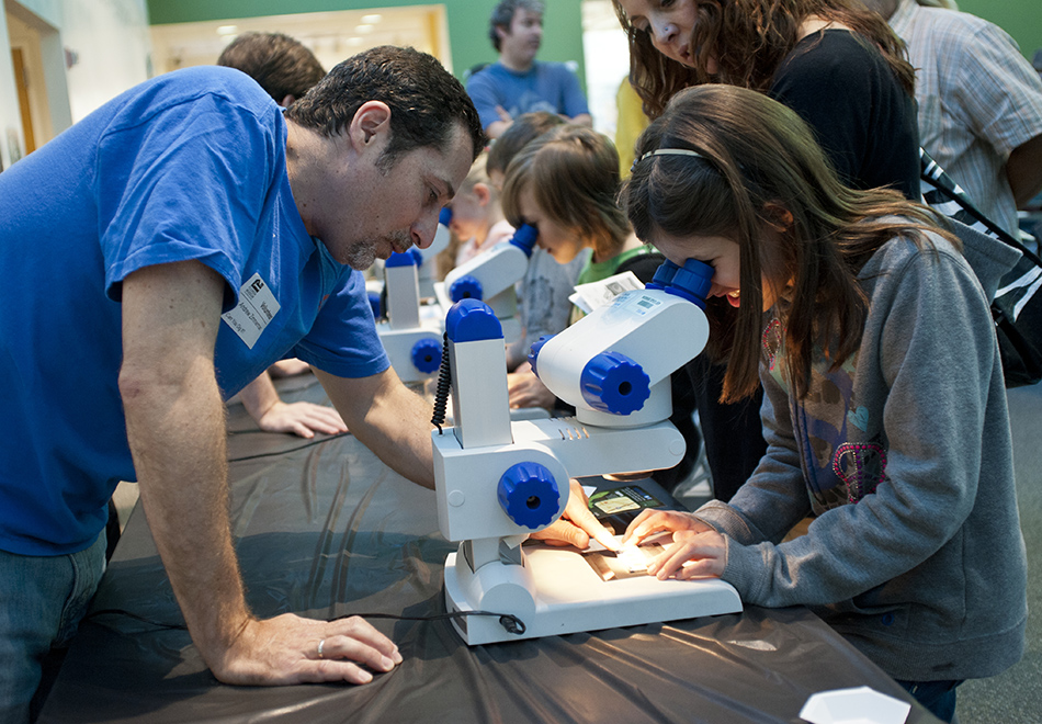 girl looking through microscope