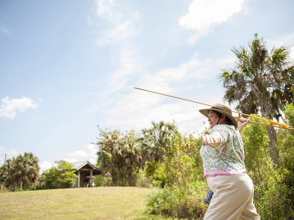 woman using atlatl outside