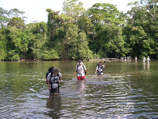 scientists crossing a river in Costa Rica