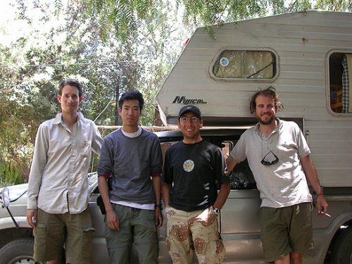scientists leaning agaist a camper truck