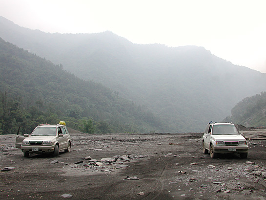 two offroad vehicles on an unpaved mountain road