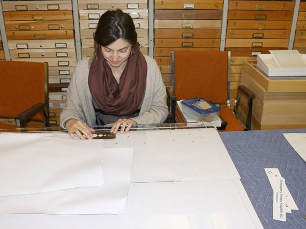 person measuring dots with a ruler