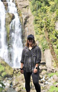 person standing in-front of a waterfall