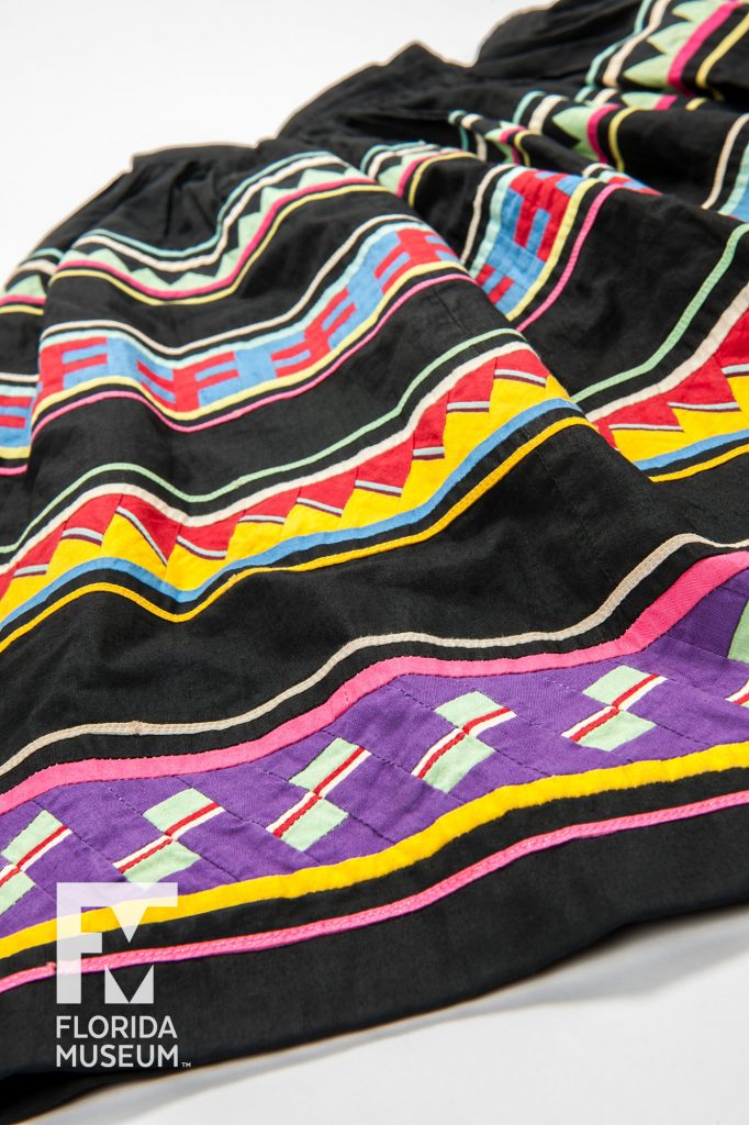 Woman’s Patchwork Skirt. Fabric alternates between black and multicolored patchwork stripes.