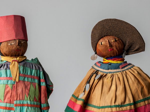 close up of two dolls dress in bright clothing