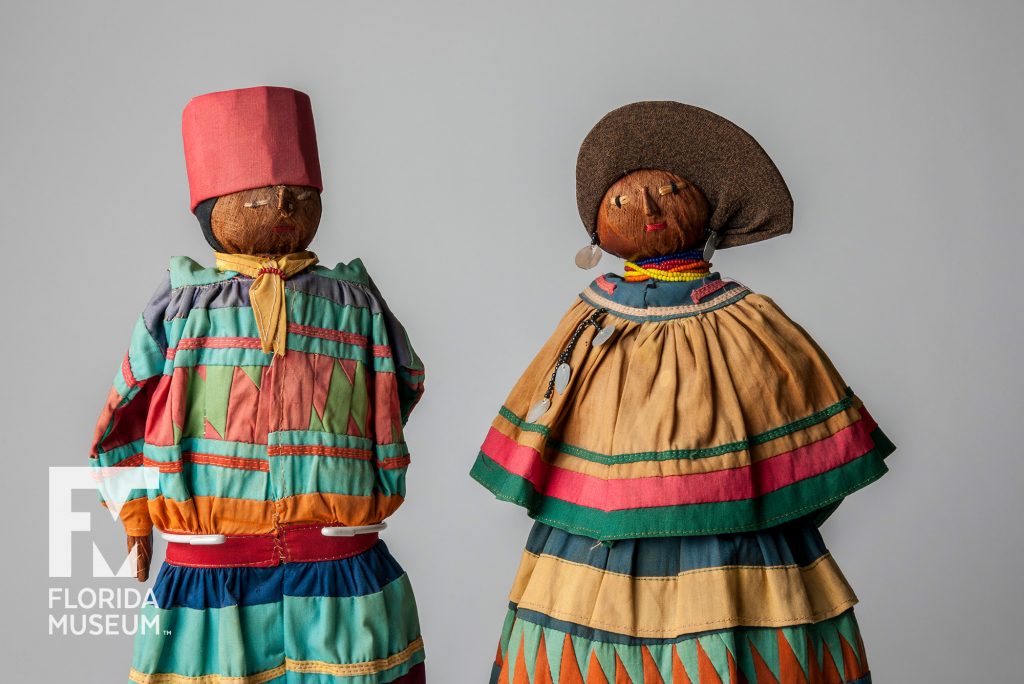close up of two dolls dress in bright clothing