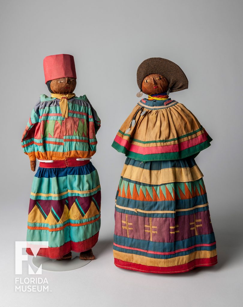 two dolls dress in bright clothing