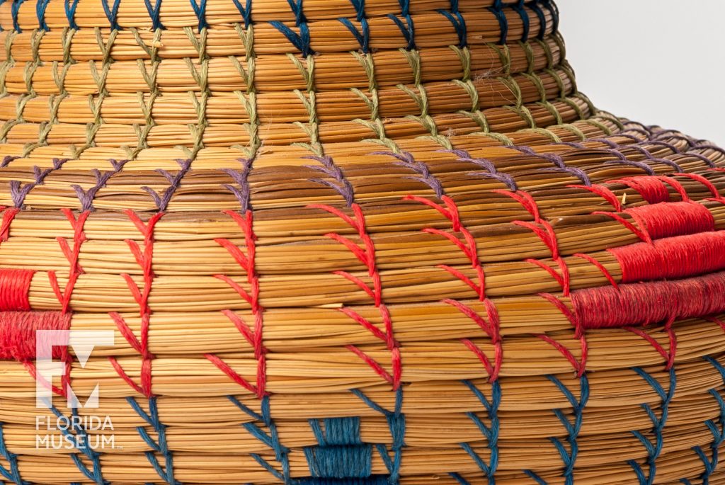 close up of coiled basked woven with several colors of thread