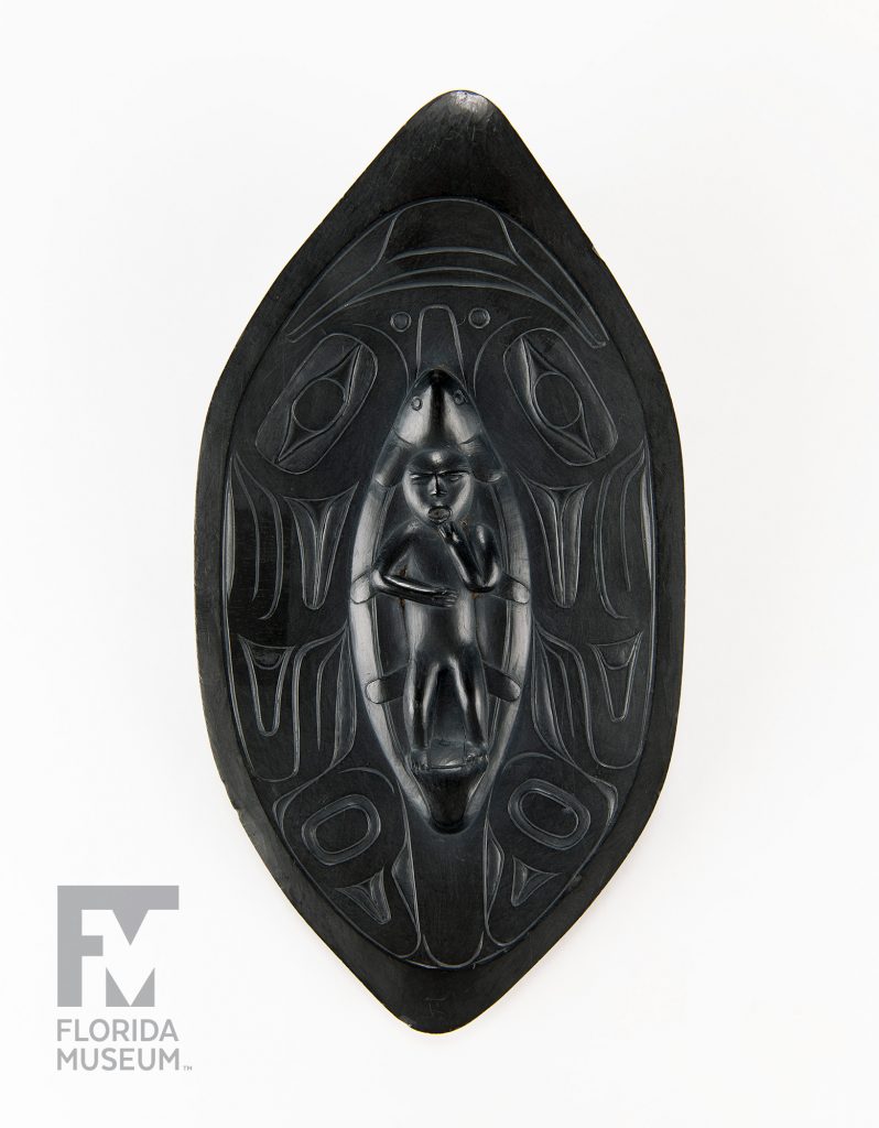 elongated oval with a figure carved at the center