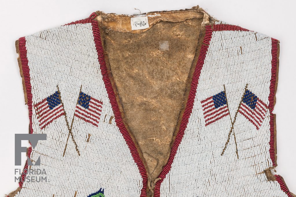 the collar of a heavily beaded vest. The vest is beaded with several American flags
