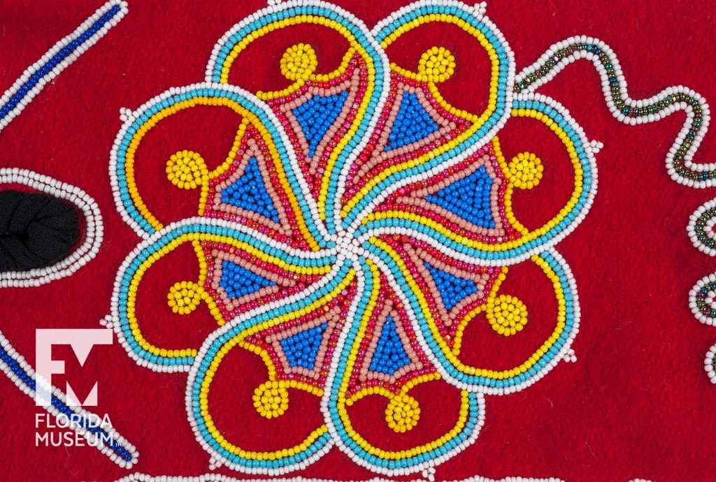 close up of designs sewn from multi-colored seed beads