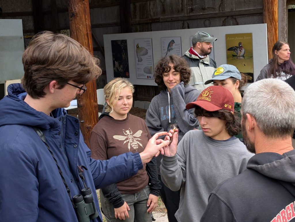 Students learn how to handle birds at the UFBO