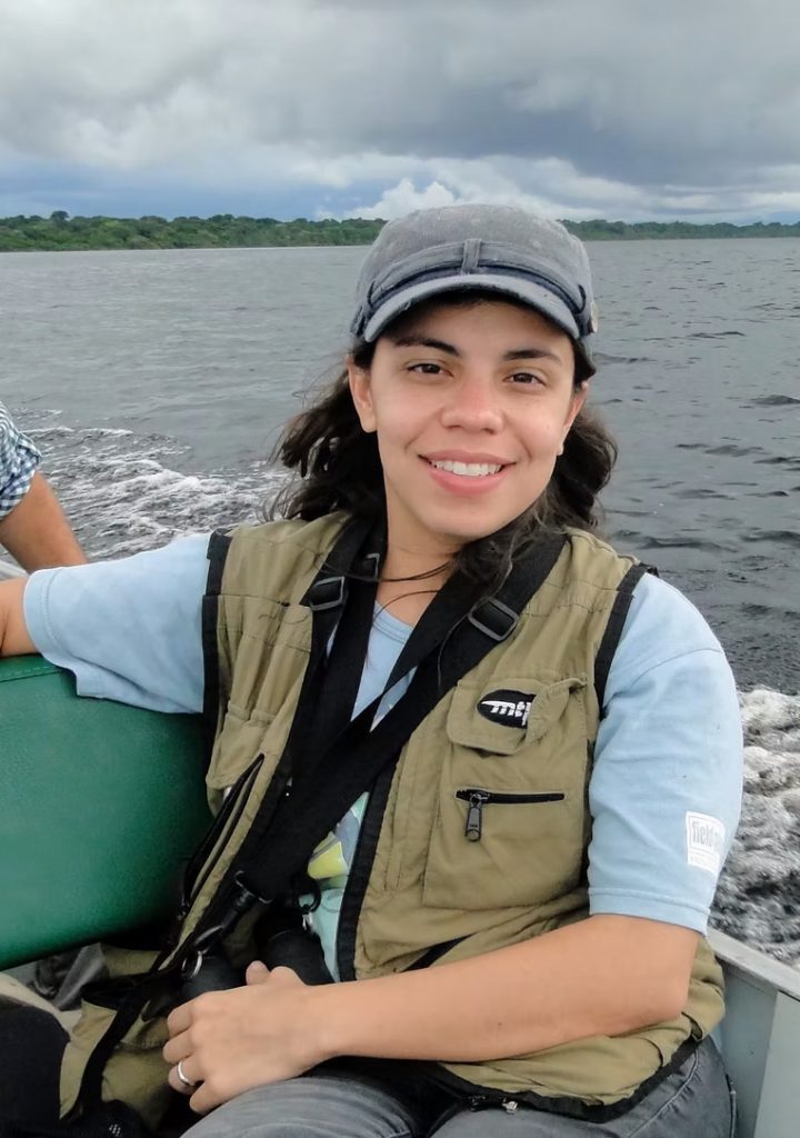 Glaucia Del-Rio on a boat smiling at the camera