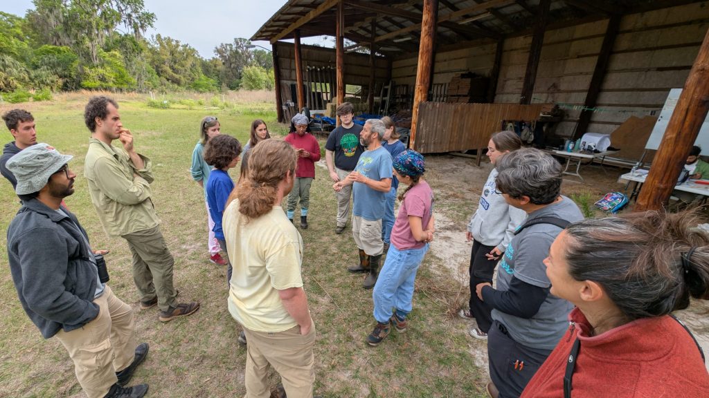 Charlie Muise, teaches trainees and volunteers how to handle birds and collect data