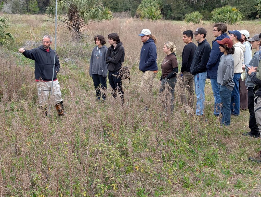 UFBO manager Charlie Muise teaches students how to set up mistnets and capture birds