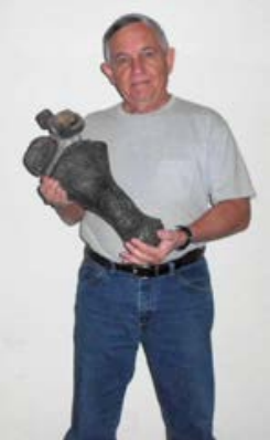 George holding rare erasmosaur paddle bones he donated to ALMNH, now on view at Smith Hall. Photo courtesy of George Martin
