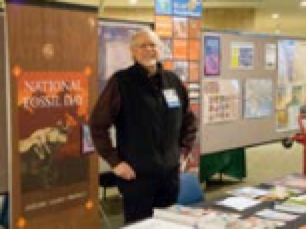 BLM paleontologist and symposium speaker Brent Breithaupt with BLM exhibit