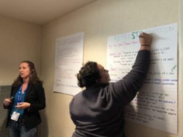 Jeanette Pirlo putting the final touches on “RepreSTEMtation” while Adriane Lam discusses place-based-learning using MacroStrat.