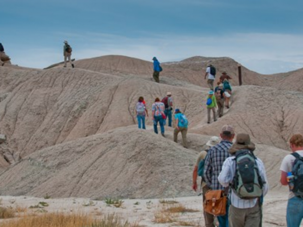 People marching through the rock column at Toadstool Park, Nebraska