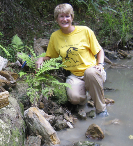 Linda McCall at Beef Creek, Jasper, TX surrounded by petrified wood