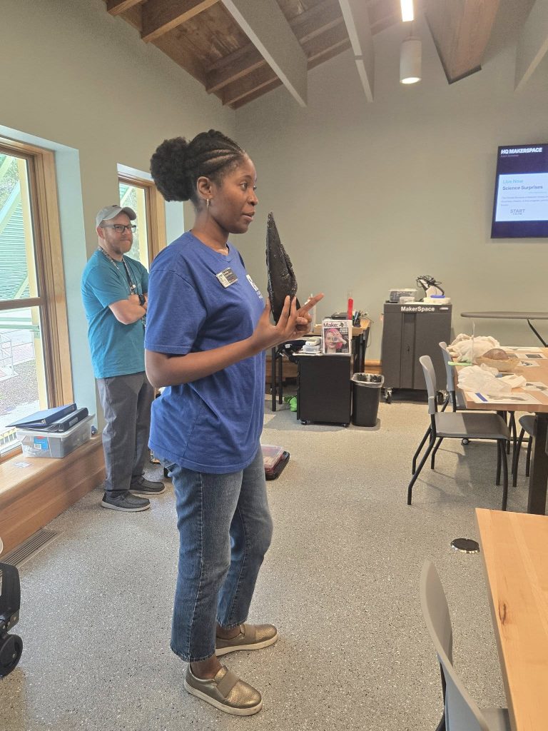 Education team members speaking at the front of a classroom