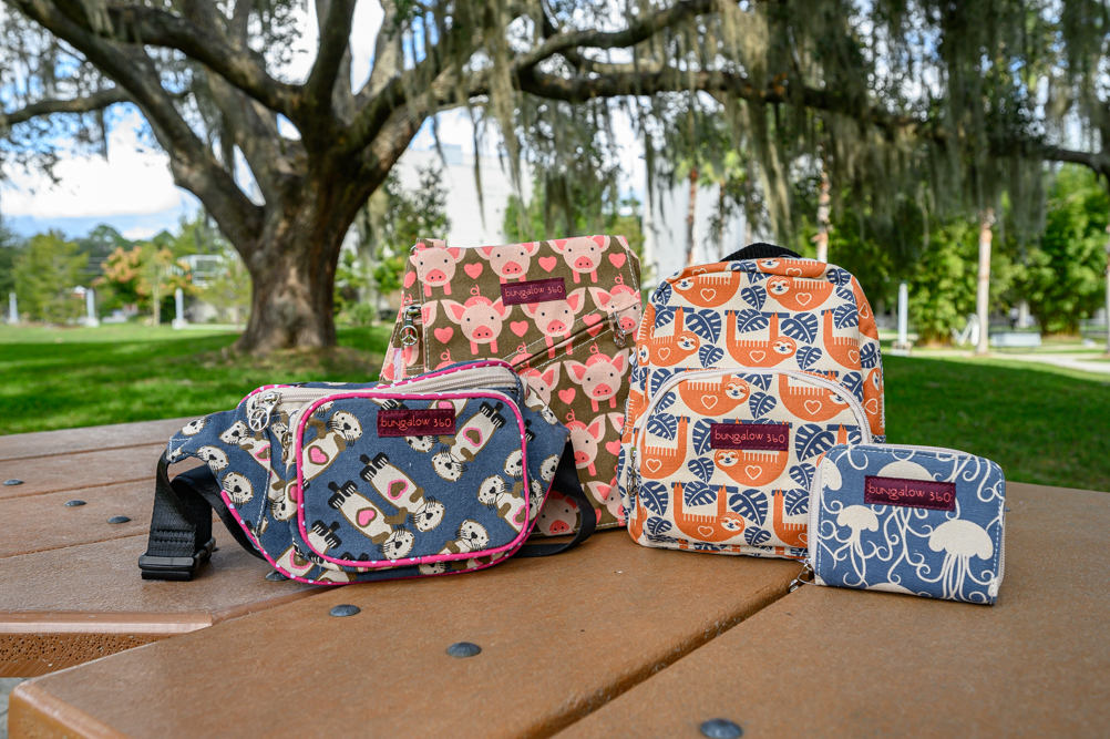 several print bags on a table under a tree
