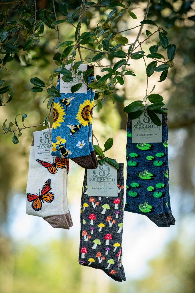 several socks with insect, animal, and botanical patterns