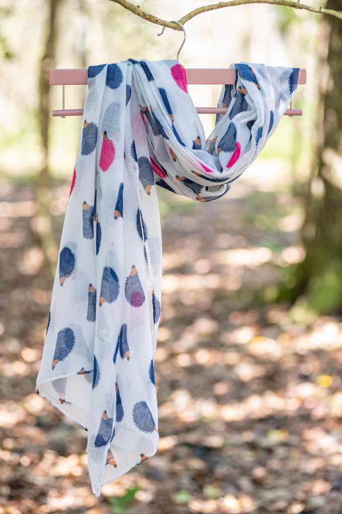 lightweight white scarf with printed with pink and blue hedgehogs