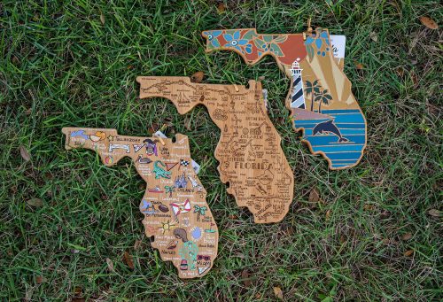 Florida shaped cheese board pained or carved with Florida-themed designs