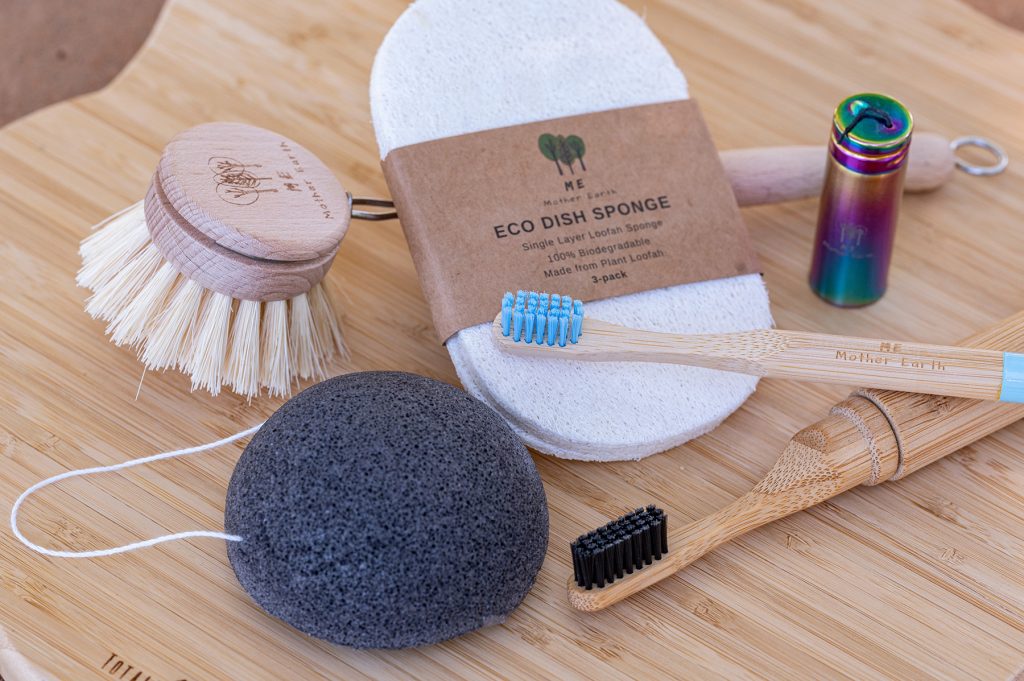 collection of kitchen and bath cleaning supplies, sponge, tooth brushes, cleaning brushes, made from biodegradable and bamboo materials