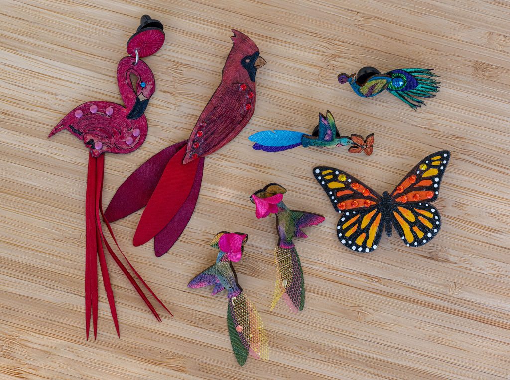 collection of bird and butterfly shaped broaches and earrings