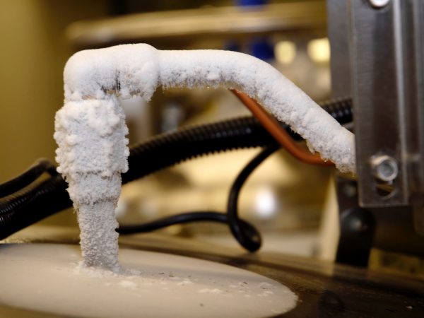 The intake valve freezes and frosts as liquid nitrogen is pumped into the freezer to maintain its temperature of minus 320 degrees Fahrenheit. (c) Photo by Jeff Gage.