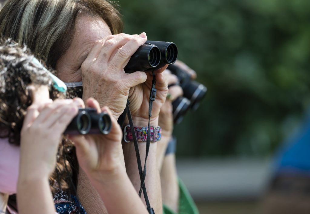 people looking through binoculars