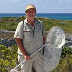 scientist in field with insect net