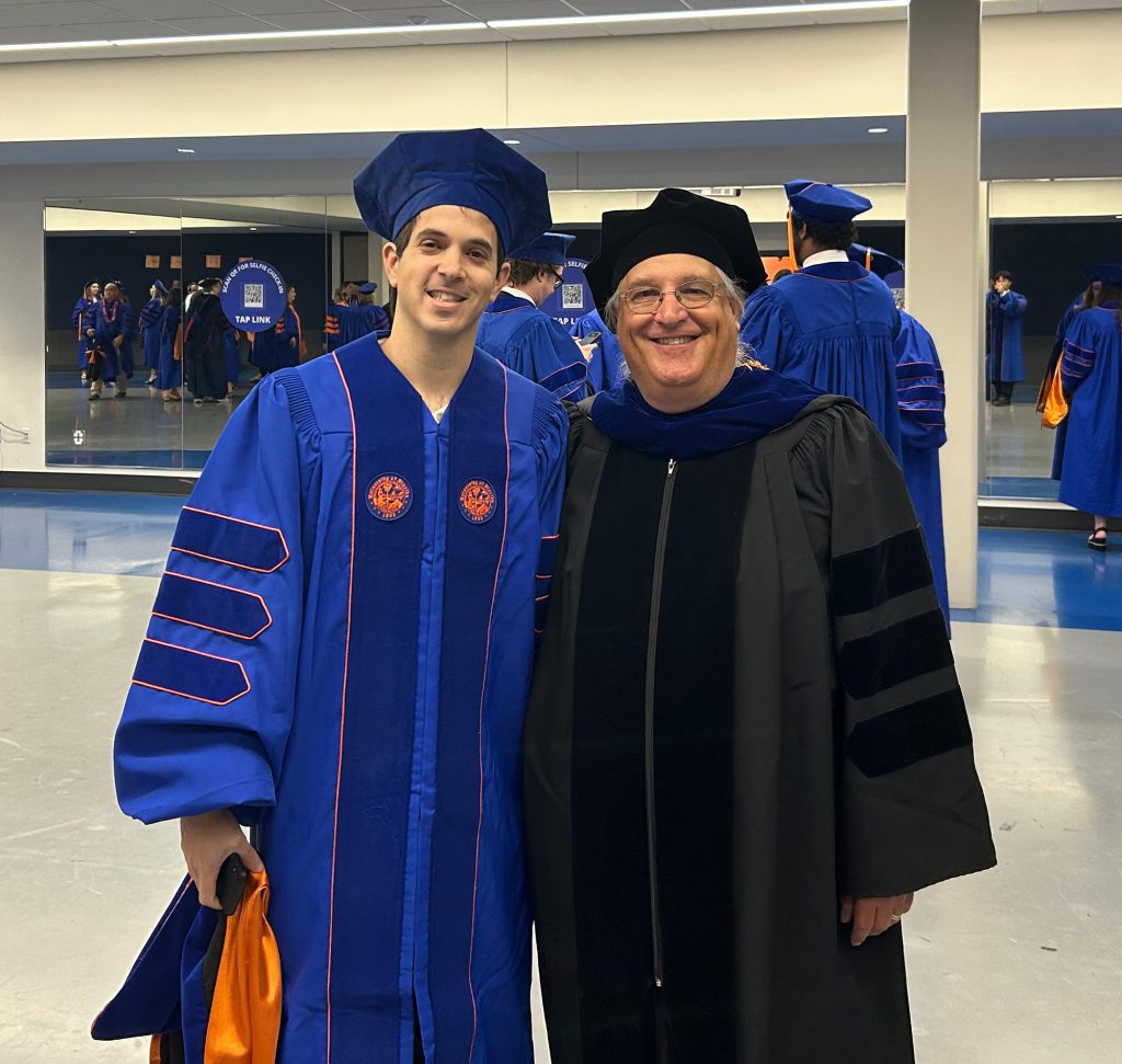two men in graduation robes and caps