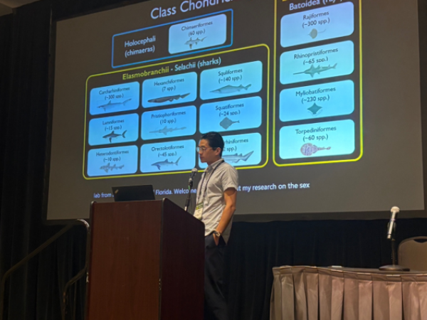 Adrian Lee giving their oral presentation at the Evolution 2025 conference