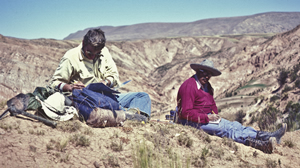 old photo of two researchers on a desert hillside