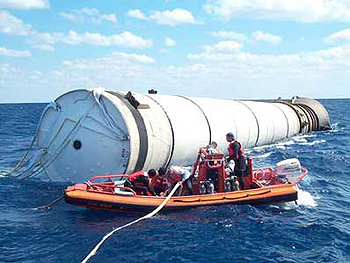 workers retrieve rocket boosters