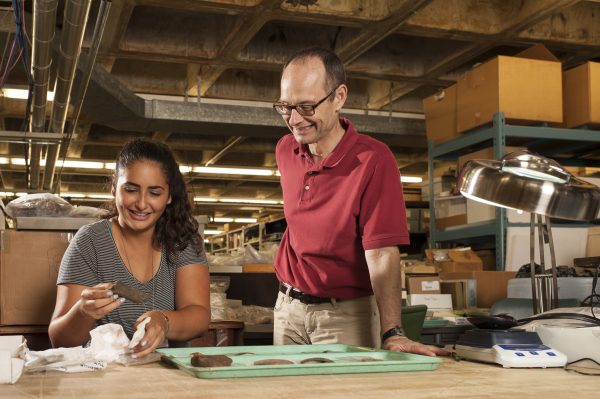 Charles Cobb and student Domenique Sorresso examine Native American pottery sherd