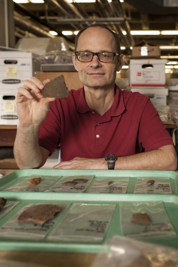 Charles Cobb displays a pottery sherd