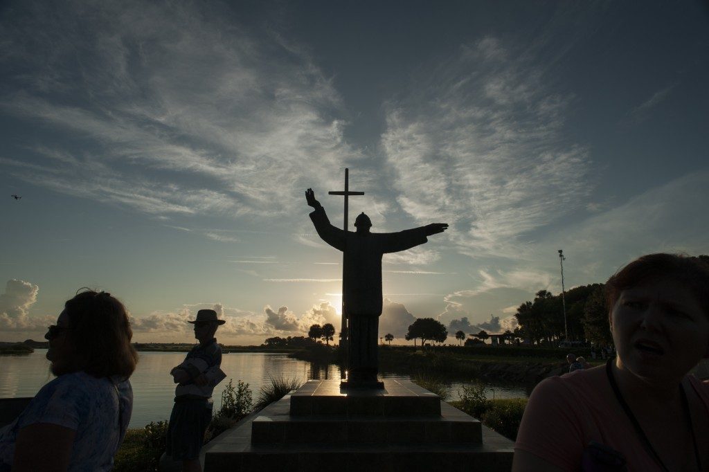 silhouette of man and cross