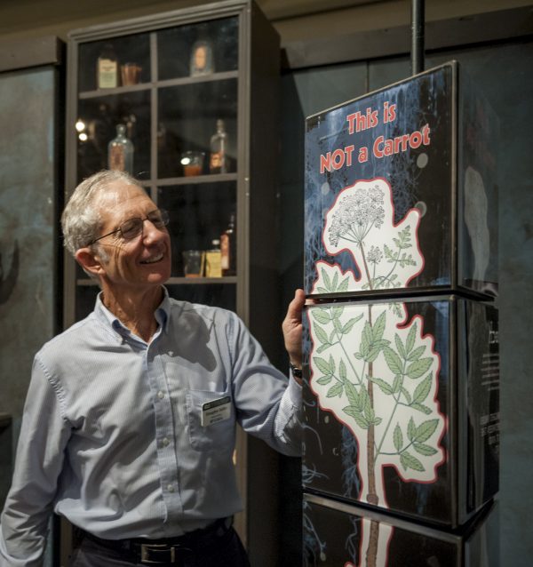 Doug stands by a interactive display reading 