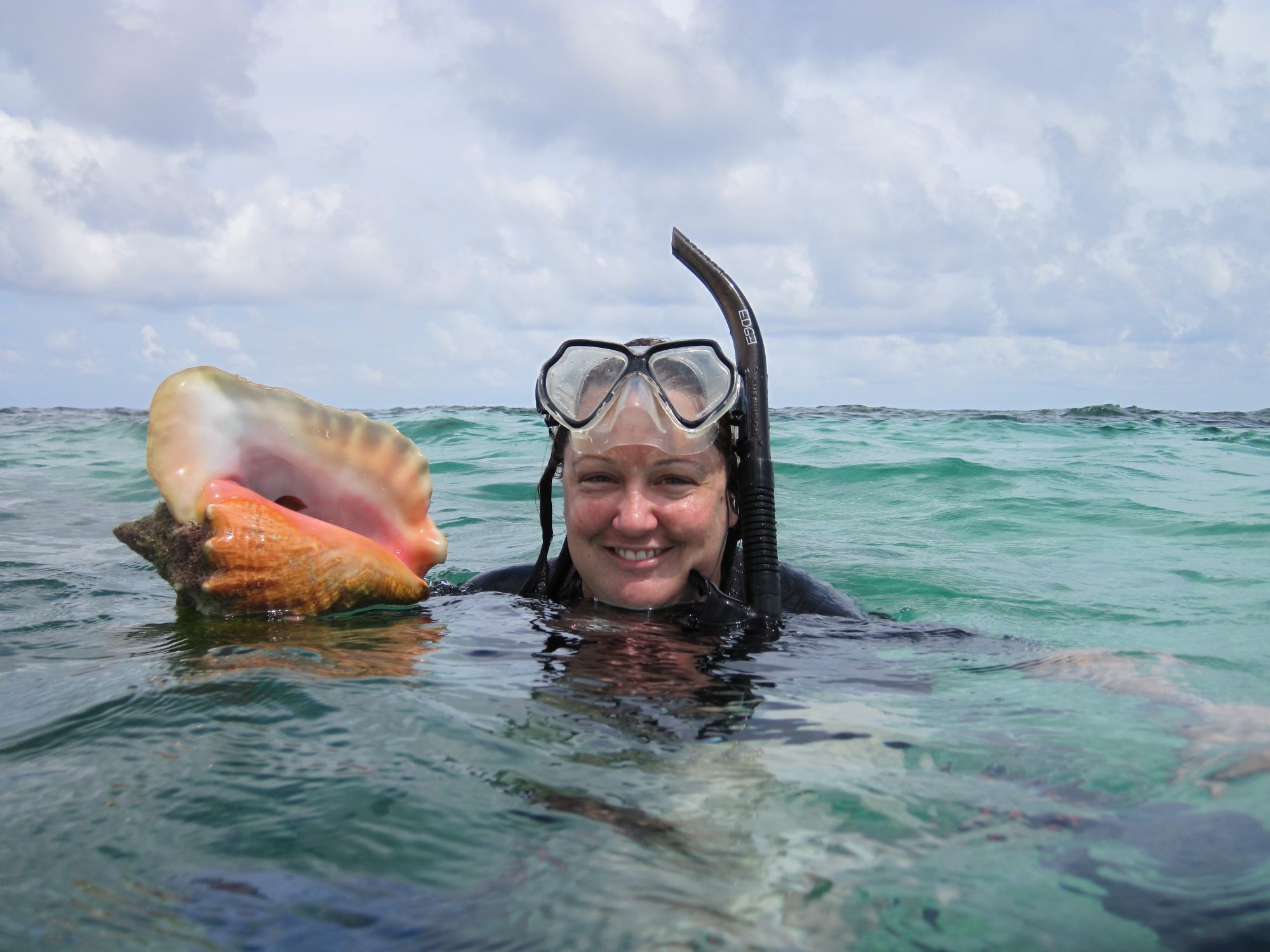 Carrie Tyler snorkeling with conch shell
