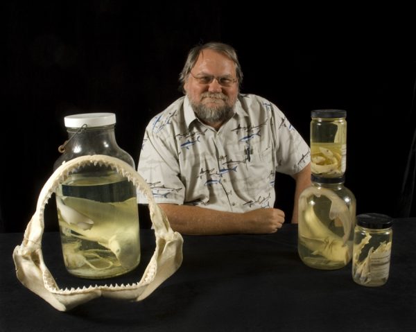 George Burgess with shark bones and specimens