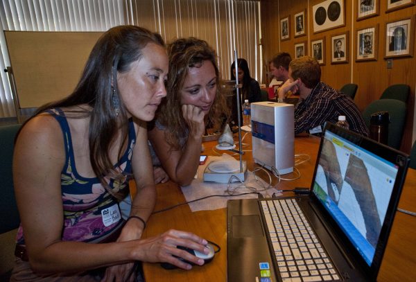 Claudia and Laura working on a laptop