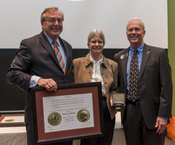 University of Florida President W. Kent Fuchs, left, and Museum Director Doug Jones present the 2017 Archie Carr Medal Award to Karen Bjorndal. Florida Museum photo by Kristen Grace