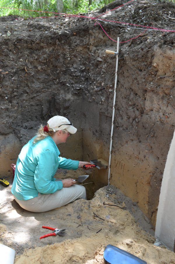 Researcher collects sediment at site
