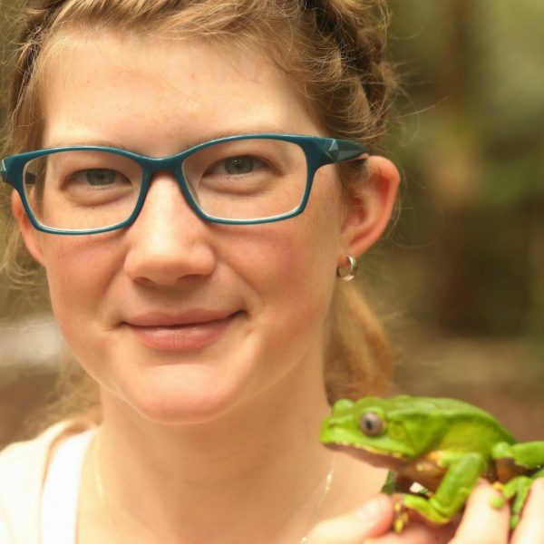 A photo of Graslie holding a green amphibian