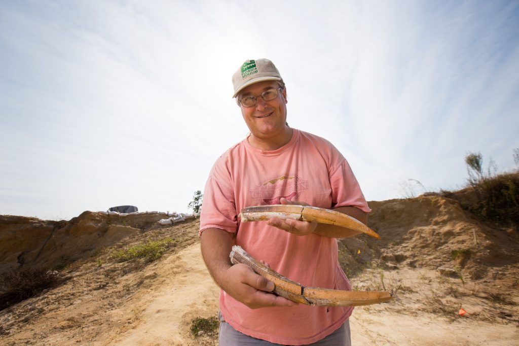Jon Bloch holding fossil tusks